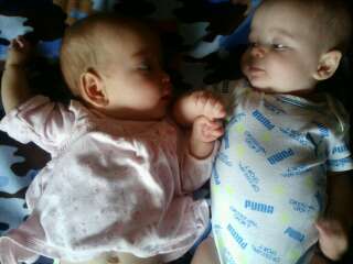 Colton holding Gracelynn's hand to help her go to sleep