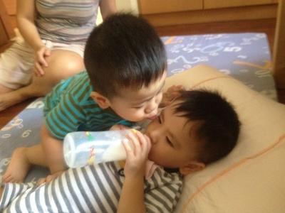 Joash giving his twin brother Nathan an impromptu kiss