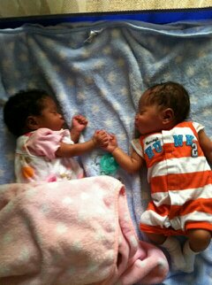 Joshua and Juliana holding hands while they sleep